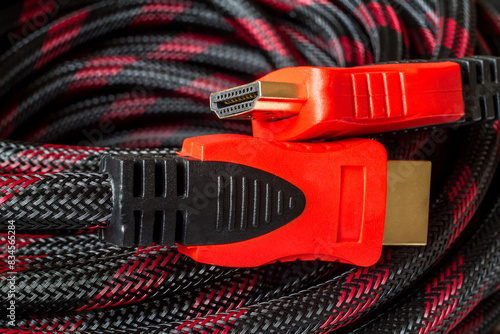 Two red HDMI connectors close-up. Signal transmission cable.