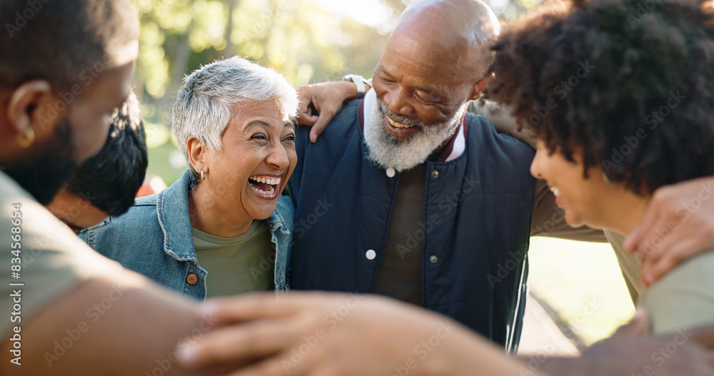 © peopleimages.com - Huddle, happy and group of people outdoor with collaboration, teamwork and solidarity for charity work. Hug, smile and volunteer or ngo in park with cooperation, community and together for donation