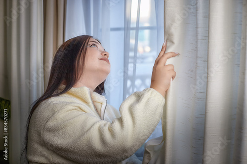 People and lifestyle concept. Body positiv. Indoor portrait of positive young Caucasian girl with chubby cheeks enjoying at home, smiling