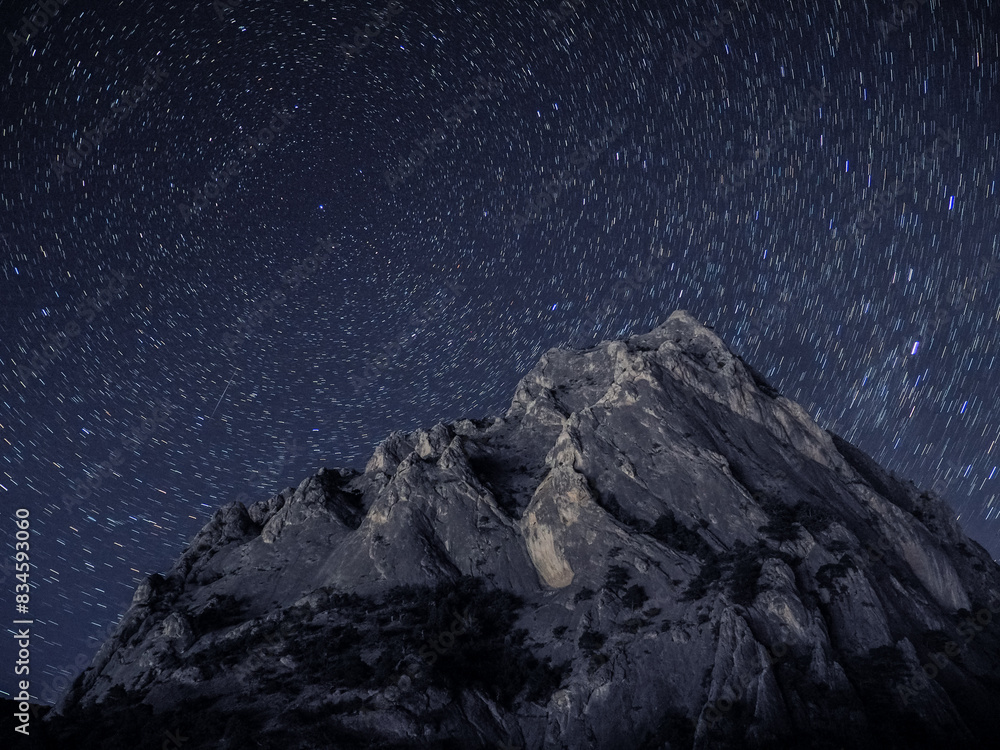 Rock under scarry sky at night astrophotography