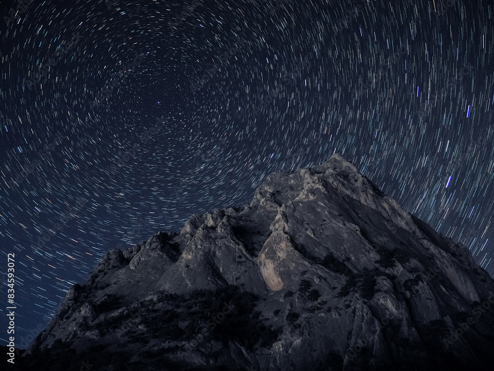 Rock under scarry sky at night astrophotography