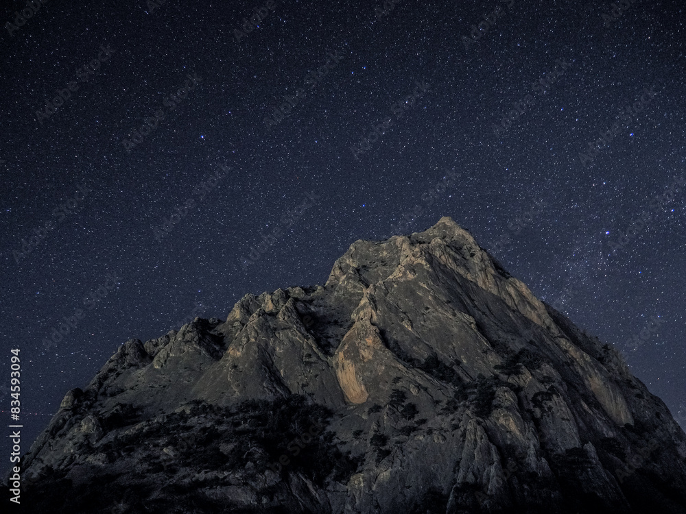 Rock under scarry sky at night astrophotography