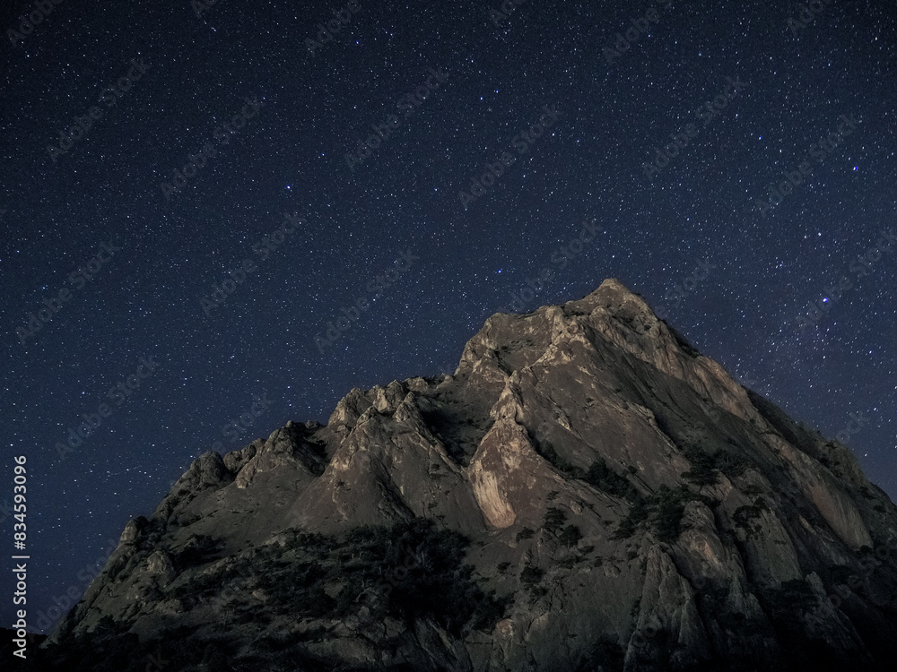 Rock under scarry sky at night astrophotography