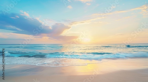 A serene beach scene at sunset with smooth sand and ample space in the sky for adding text.