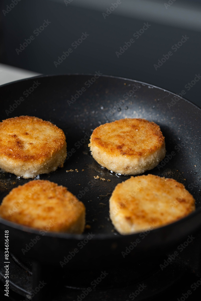 Meatballs or small meat patties cutlets sizzling in oil while frying in a pan on the stove. Concept of home cooking, traditional recipes, and culinary preparation Meatballs or small meat patties cutlets sizzling in oil while frying in a pan on the stove. Concept of home cooking, traditional recipes, and culinary preparation