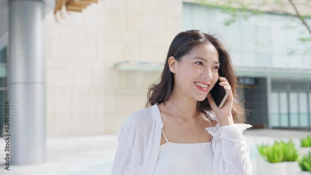 slow motion young asian business woman walking in the urban city street talking on the mobile phone happy smile slow motion young asian business woman walking in the urban city street talking on the mobile phone happy smile