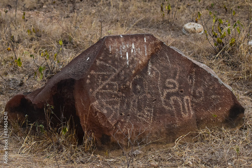 Carved rocks with ancient petroglyphs created by a past culture, a testament to early human artistry and symbolism. photo