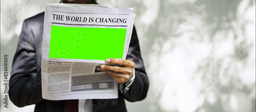 Obraz na plátně Newspaper Page With Green Screen, Man holding paper, mock up