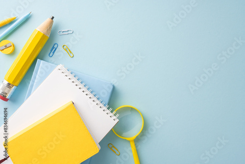 Obraz na plátně Assorted school supplies including notepads, paperclips, pencil and magnifying g