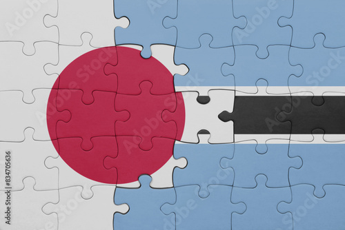 puzzle with the colourful national flag of botswana and flag of japan.