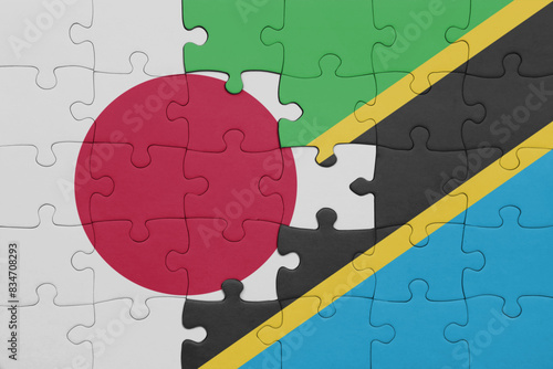 puzzle with the colourful national flag of tanzania and flag of japan.