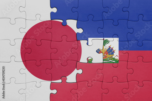 puzzle with the colourful national flag of haiti and flag of japan.