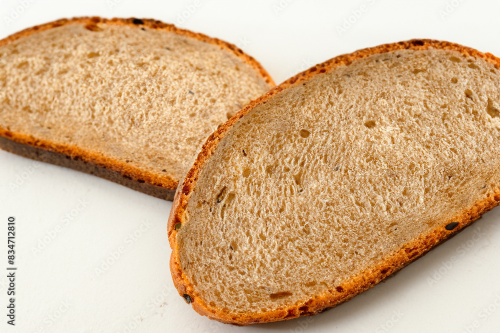 bread composition. Two slices of white bread lie on a white background, close-up top view food concept bread composition. Two slices of white bread lie on a white background, close-up top view food concept