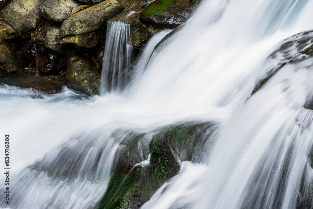The stones under the waterfall, close-up waterfall as a background. The stones under the waterfall, close-up waterfall as a background.