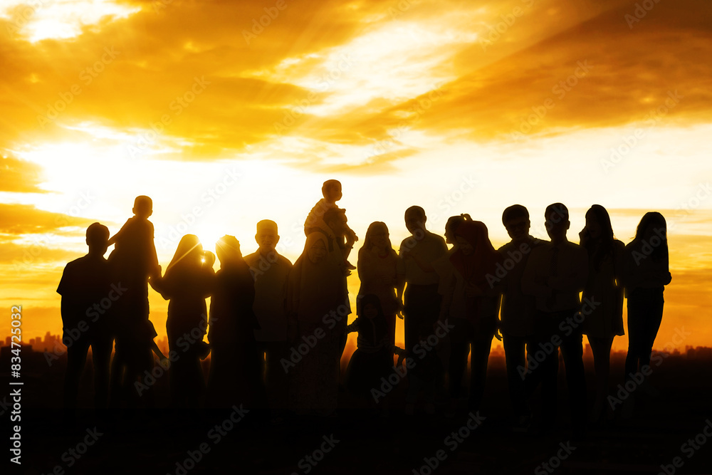 Silhouette of a big family holding each other and watching a beautiful sunset Silhouette of a big family holding each other and watching a beautiful sunset