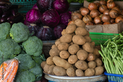 Beautifully arranged fresh vegetables at a traditional market, for sale.