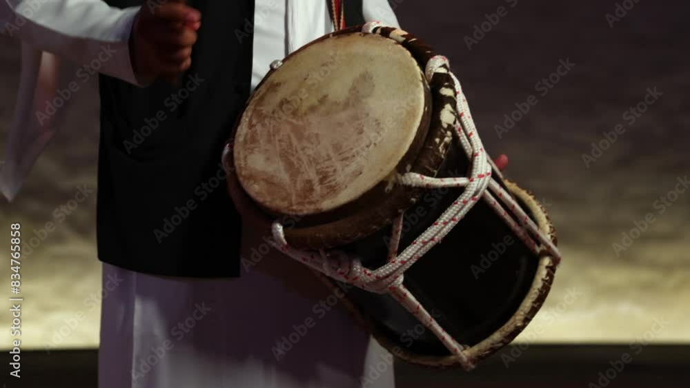 Man playing traditional Emirati drums percussion instrument, hands only in frame Man playing traditional Emirati drums percussion instrument, hands only in frame