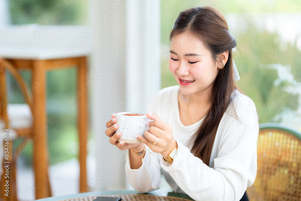 Portrait of beautiful happy Smiling asian woman relaxing sitting in cafe interior in coffee shop background,Business Lifestyle summer holiday concept Portrait of beautiful happy Smiling asian woman relaxing sitting in cafe interior in coffee shop background,Business Lifestyle summer holiday concept