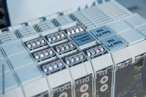 Programmable Logic Controller PLC comprised of analog and digital input and output with power supply and processor module, selective focus.