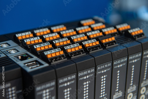 Programmable Logic Controller PLC comprised of analog and digital input and output with power supply and processor module, selective focus.