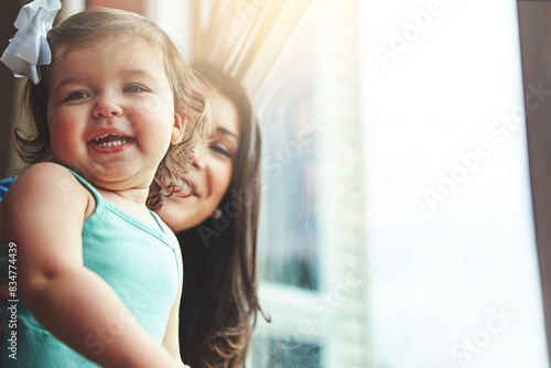Mother, toddler and happiness or house window, love and bonding with family in apartment together with girl baby. Childhood development, growth and smile or caring, woman and hand pointing in home © peopleimages.com
