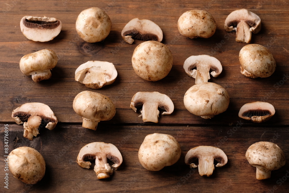 champignons are edible mushrooms that are almost round like buttons. mushroom is the most widely cultivated mushroom in the world. Agaricus bisporus. served on a rustic wooden table. champignons are edible mushrooms that are almost round like buttons. mushroom is the most widely cultivated mushroom in the world. Agaricus bisporus. served on a rustic wooden table.