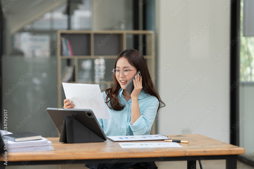 Asian business woman working with documents office. Asian business woman working with documents office.