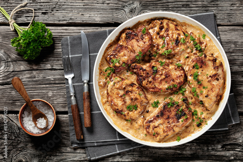 creamy smothered pork chops cooked in onion gravy photo