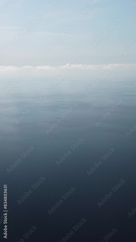 Aerial view from above on calm azure sea. Small waves on water surface in motion blur. Nature summer ocean sea beach background. Nobody. Weather and climate change. Holiday, vacation and travel idea. Aerial view from above on calm azure sea. Small waves on water surface in motion blur. Nature summer ocean sea beach background. Nobody. Weather and climate change. Holiday, vacation and travel idea.