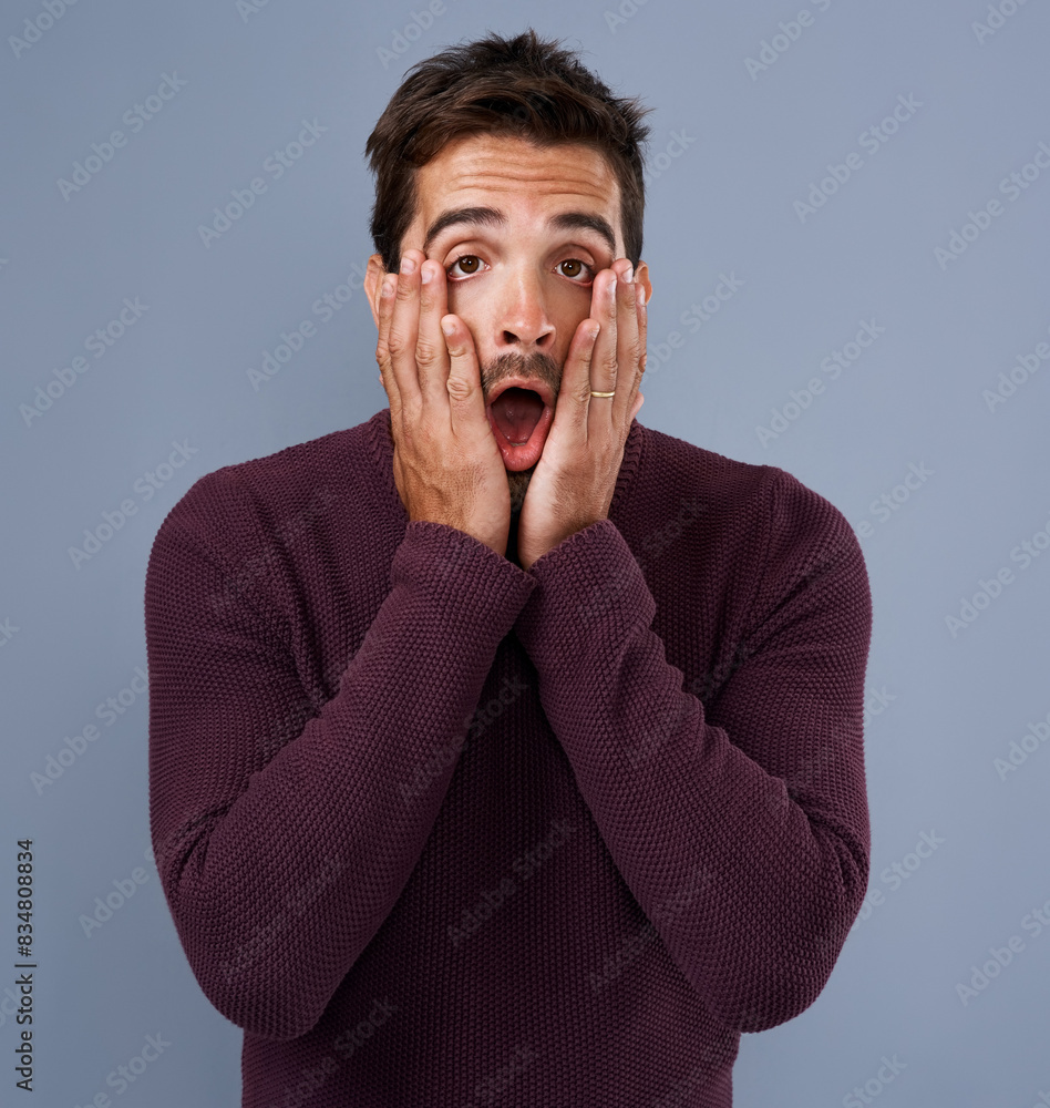 Surprised, portrait and man with hands on face in studio for news, gossip or announcement on blue background. Wow, shocked and male person for prize giveaway, wtf reaction or omg emoji with mockup Surprised, portrait and man with hands on face in studio for news, gossip or announcement on blue background. Wow, shocked and male person for prize giveaway, wtf reaction or omg emoji with mockup