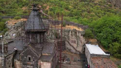 Old stone tower at medieval Armenia Geghard Monastery under renovation photo