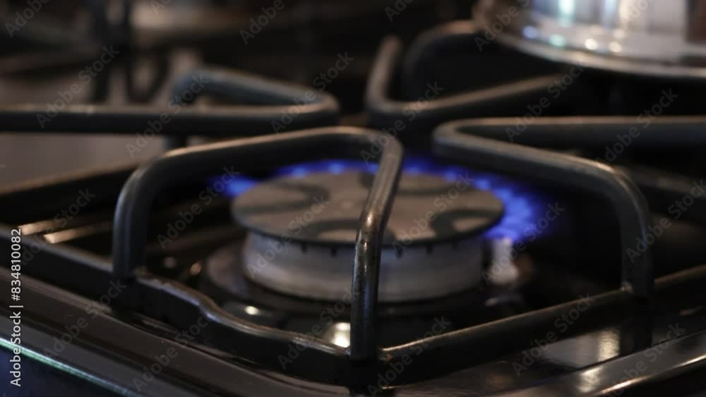 Tight shot of kitchen gas range lighting with fire. Tight shot of kitchen gas range lighting with fire.