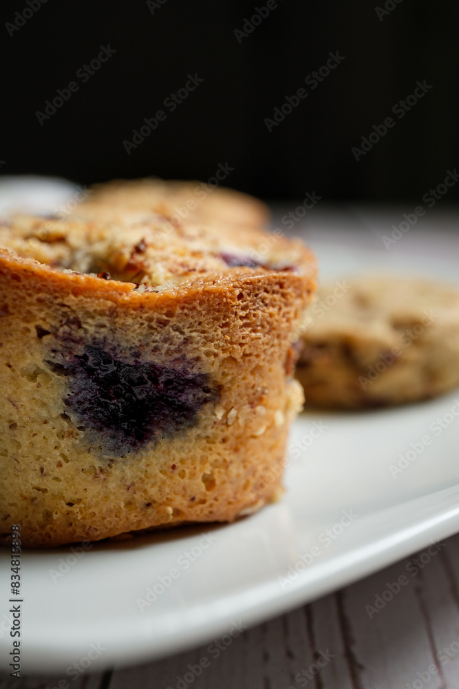 Plate with a homemade cupcake and some blurred cookies. Plate with a homemade cupcake and some blurred cookies.