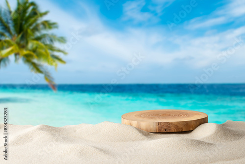 Fototapeta Naklejka Na Ścianę i Meble -  Wooden pedestal with free space for your decoration on tropical summer sand beach