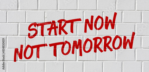  Graffiti on a brick wall - Start now not tomorrow