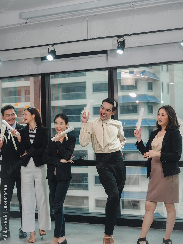 Fototapeta premium Group of businesspeople with diverse genders (LGBT) celebrate faked business certificates together in the meeting room. Business people teamwork..