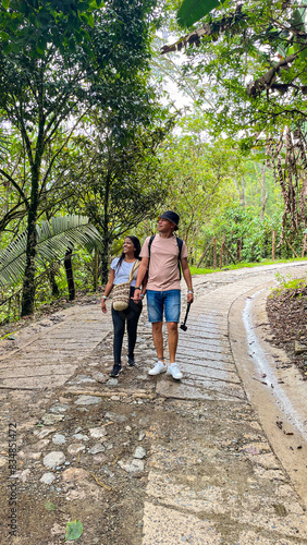 Couple Walking on Jungle Path with Camera