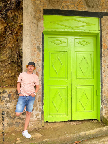 Man Leaning Against Bright Green Doorway