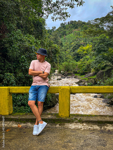 Man Enjoying Nature on a Jungle Bridge