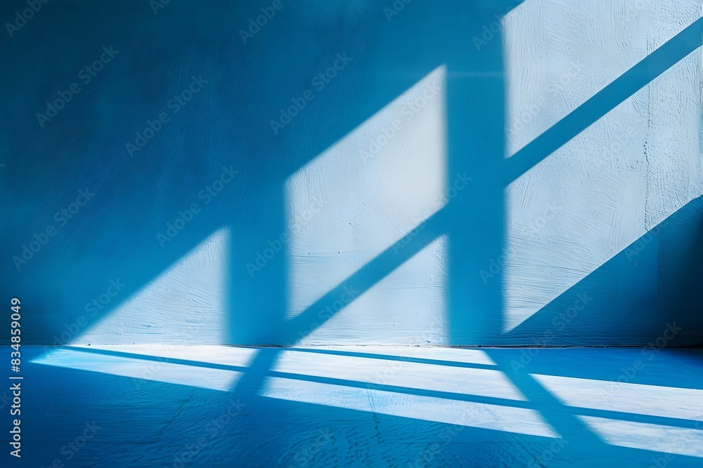 Obraz premium A blue background with the shadow of windows, light and shadows on the wall in a minimalist style