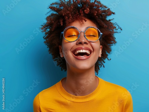 Happy woman wearing glasses in yellow shirt photo