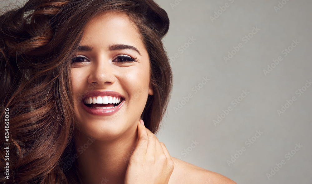 Hair, smile and space with portrait of woman in studio on gray background for keratin or shampoo treatment. Aesthetic, beauty and cosmetics with happy model on mockup for conditioning or haircare Hair, smile and space with portrait of woman in studio on gray background for keratin or shampoo treatment. Aesthetic, beauty and cosmetics with happy model on mockup for conditioning or haircare