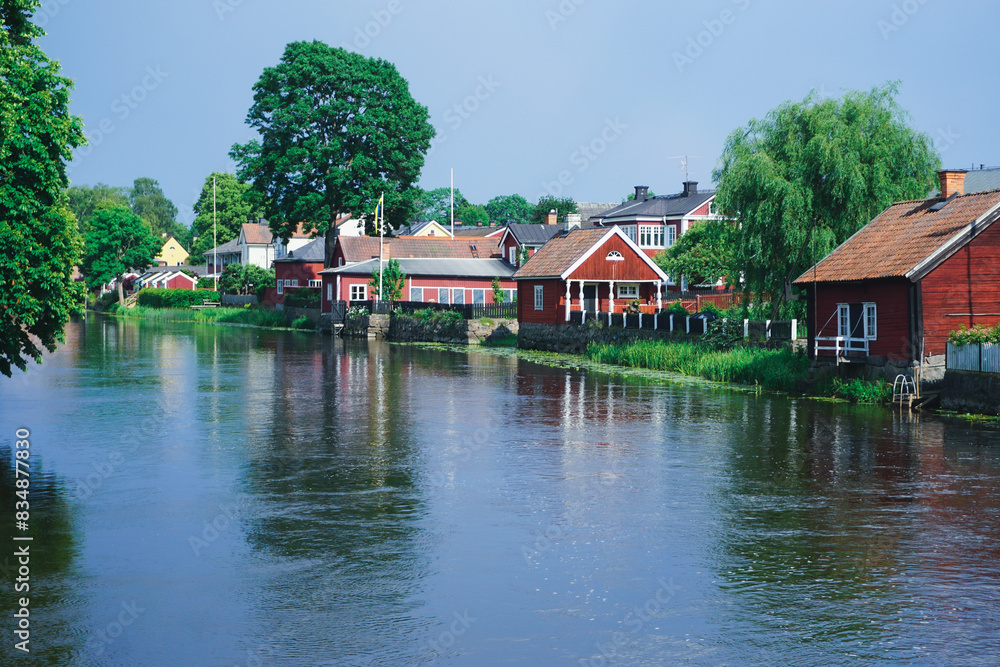 Buildings by a river during summer Buildings by a river during summer