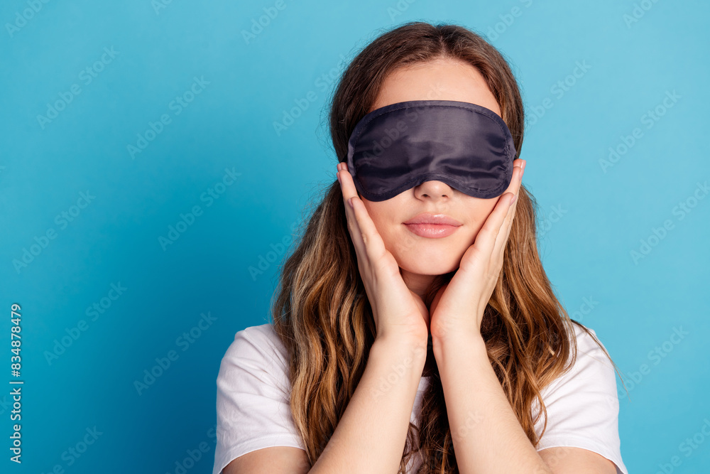 Photo of adorable lovely girl advertise white stylish sleepwear empty space isolated on blue color background Photo of adorable lovely girl advertise white stylish sleepwear empty space isolated on blue color background