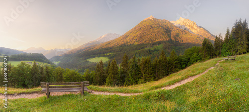Meadow with road and bench during sunset in Berchtesgaden National Park photo