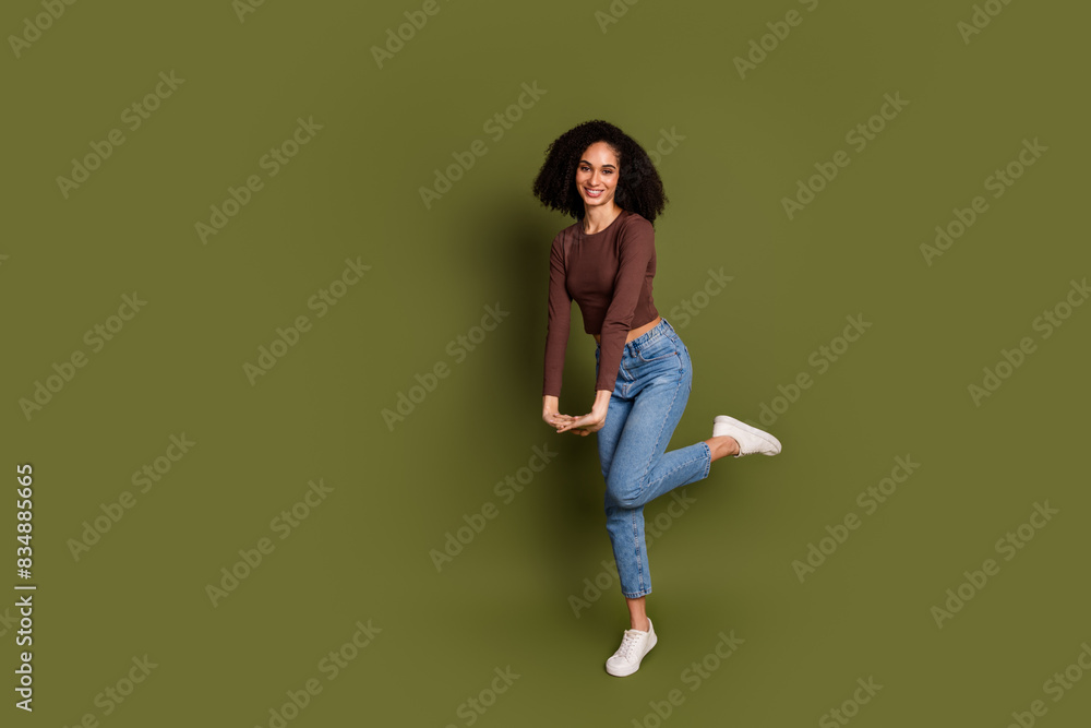 Full body photo of attractive young woman cute pose dancing dressed stylish brown clothes isolated on khaki color background Full body photo of attractive young woman cute pose dancing dressed stylish brown clothes isolated on khaki color background