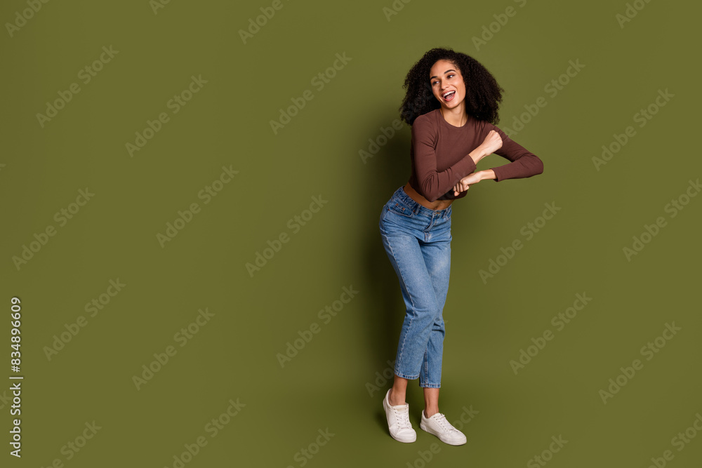 Full size photo of pretty young girl dancing have fun wear trendy brown outfit isolated on khaki color background Full size photo of pretty young girl dancing have fun wear trendy brown outfit isolated on khaki color background