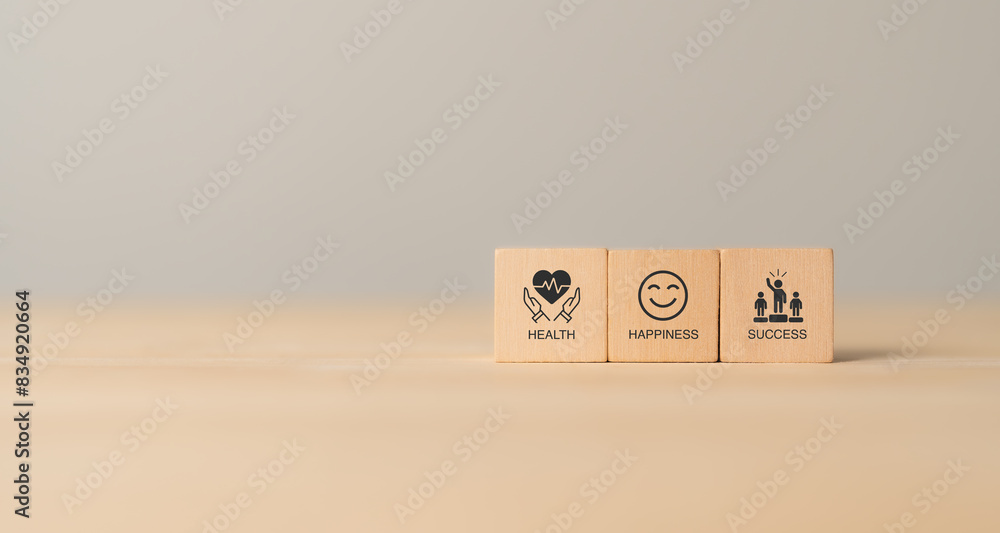 Wooden blocks with icons and words representing health, happiness, and success, symbolizing the interconnectedness of well-being and achievement. The components of a balanced and fulfilling life. Wooden blocks with icons and words representing health, happiness, and success, symbolizing the interconnectedness of well-being and achievement. The components of a balanced and fulfilling life.