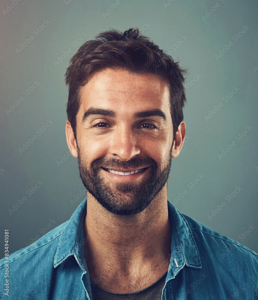 Happy man, fashion and style in portrait, trendy and cheerful with gray background in studio. Male person, smile and outfit for confidence, retail or sale in advertisement or promotion in denim shirt Happy man, fashion and style in portrait, trendy and cheerful with gray background in studio. Male person, smile and outfit for confidence, retail or sale in advertisement or promotion in denim shirt