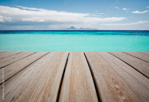 Summer vibes  A tranquil scene of wooden planks against the backdrop of the blue ocean and sky